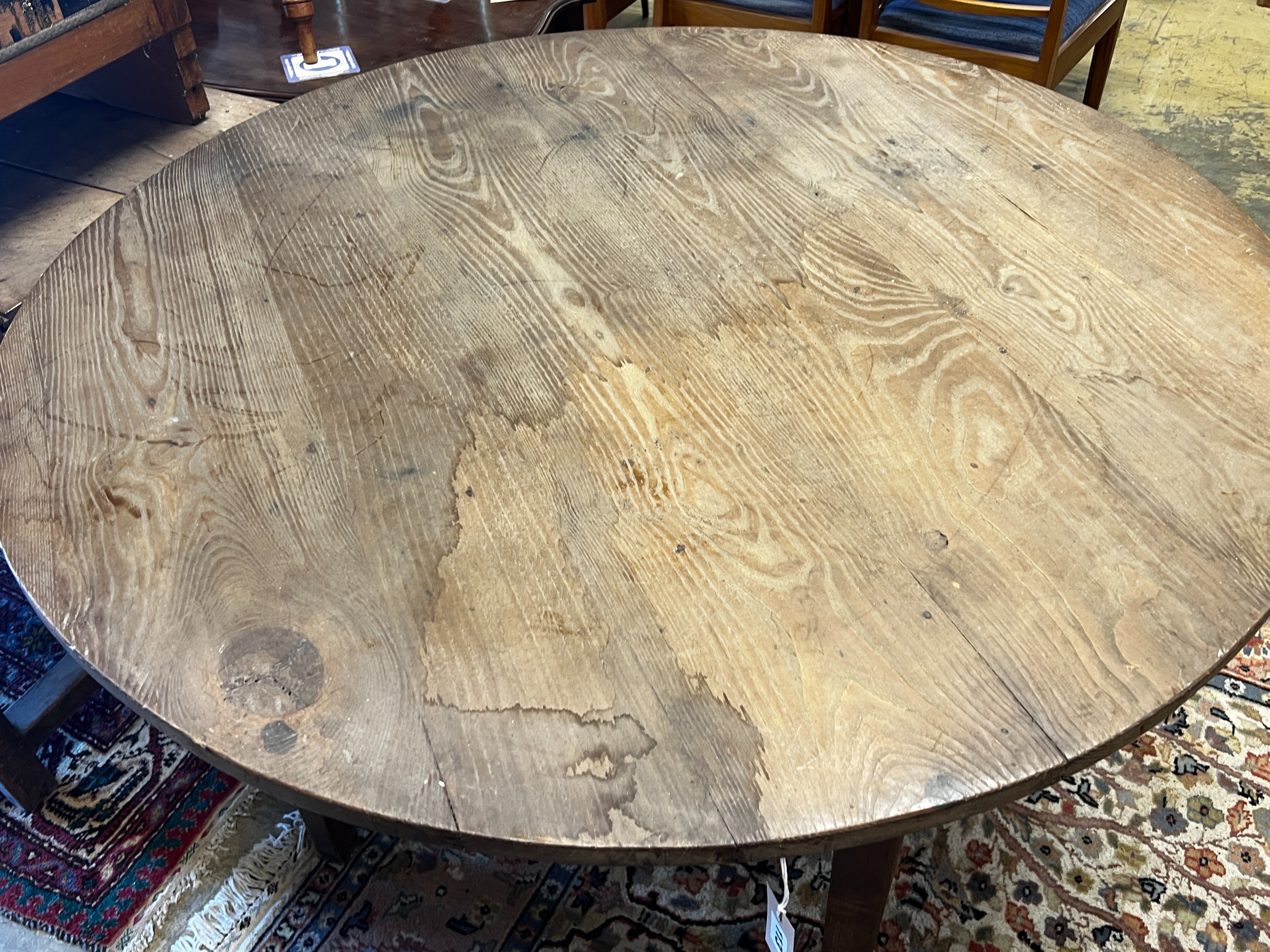 A 19th century French circular pine and oak kitchen table, diameter 116cm, height 74cm